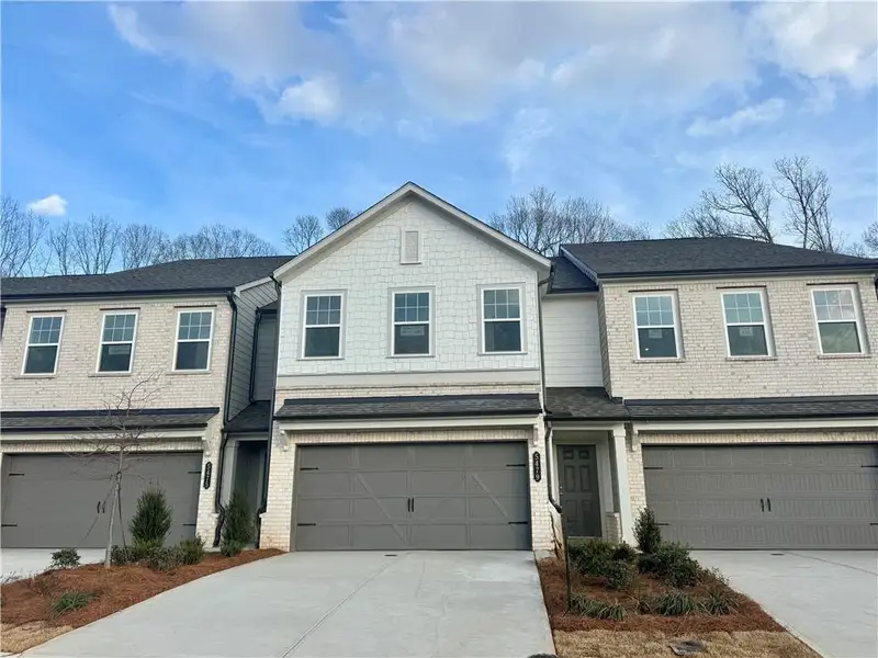 Front exterior of a new home in Eastlyn Crossing, Flowery Branch, GA, highlighting curb appeal (Image 2). Front exterior of a new home in Eastlyn Crossing, Flowery Branch, GA, highlighting curb appeal (Image 2).