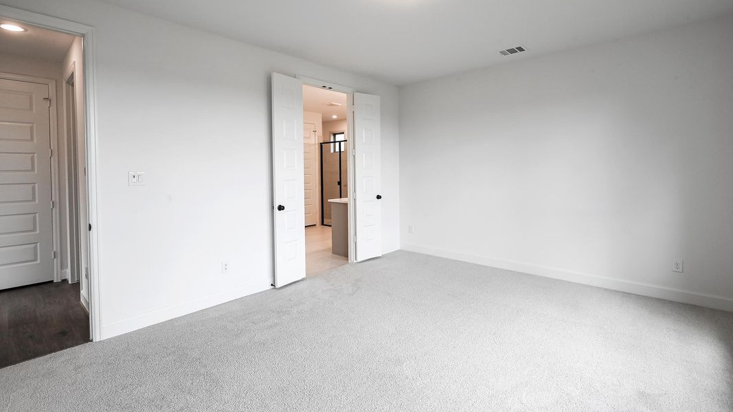Unfurnished bedroom with carpet flooring, recessed lighting, and ensuite bathroom