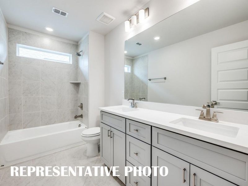 Guests will enjoy their own vanity space in this thoughtfully designed guest bath.  REPRESENTATIVE PHOTO