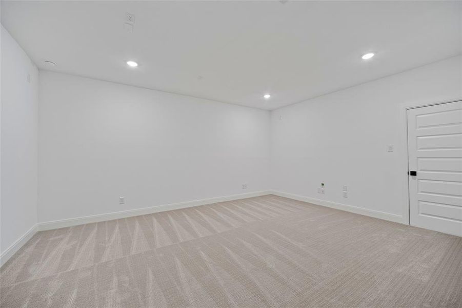 Empty room featuring light colored carpet