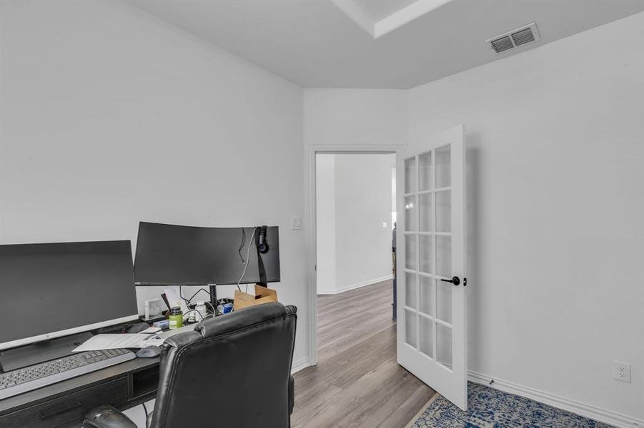 Office area with light hardwood / wood-style flooring