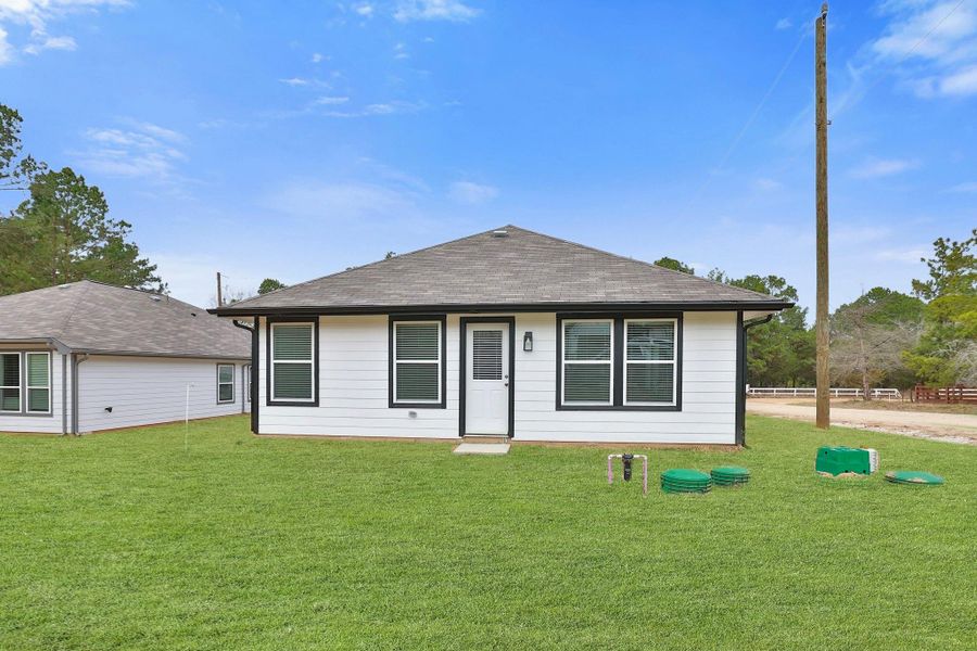 The white siding with dark trim of the house provides a charming style to the house.