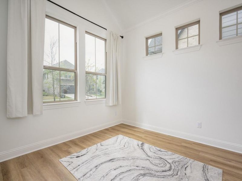 Unfurnished room with baseboards, wood finished floors, and crown molding