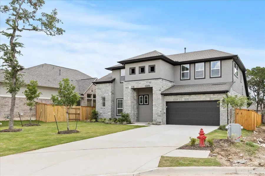 Front exterior of a new home in 6 Creeks, Kyle, TX, highlighting curb appeal (Image 1). Front exterior of a new home in 6 Creeks, Kyle, TX, highlighting curb appeal (Image 1).
