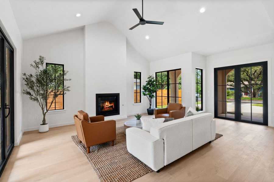A striking living space with soaring vaulted ceilings and a warm, inviting fireplace. A striking living space with soaring vaulted ceilings and a warm, inviting fireplace.