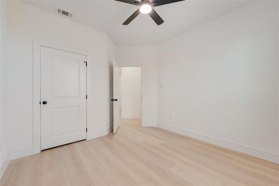 Unfurnished bedroom with light hardwood / wood-style floors and ceiling fan