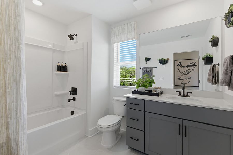 A bathroom with a tub toilet and sink.