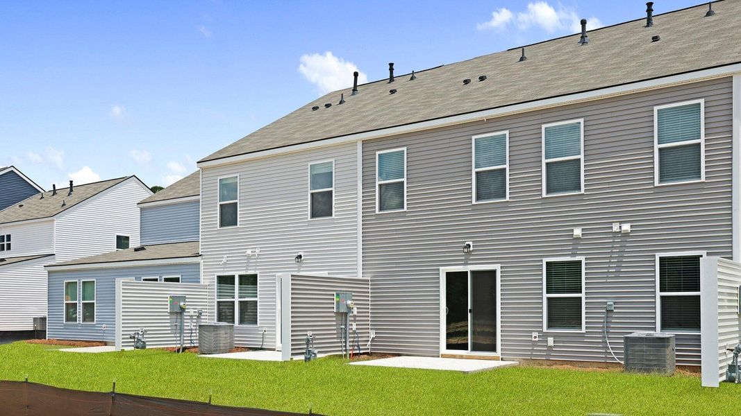Front exterior of a new home in Pine Hills Townhomes at Cane Bay, Summerville, SC, highlighting curb appeal (Image 13). Front exterior of a new home in Pine Hills Townhomes at Cane Bay, Summerville, SC, highlighting curb appeal (Image 13).