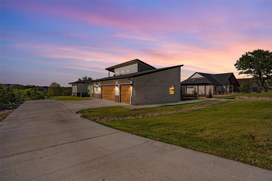 View of front facade featuring a front lawn, concrete driveway, and an attached garage View of front facade featuring a front lawn, concrete driveway, and an attached garage