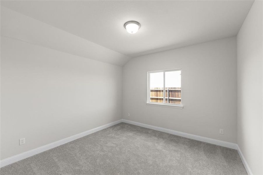 Unfurnished room with carpet floors and lofted ceiling