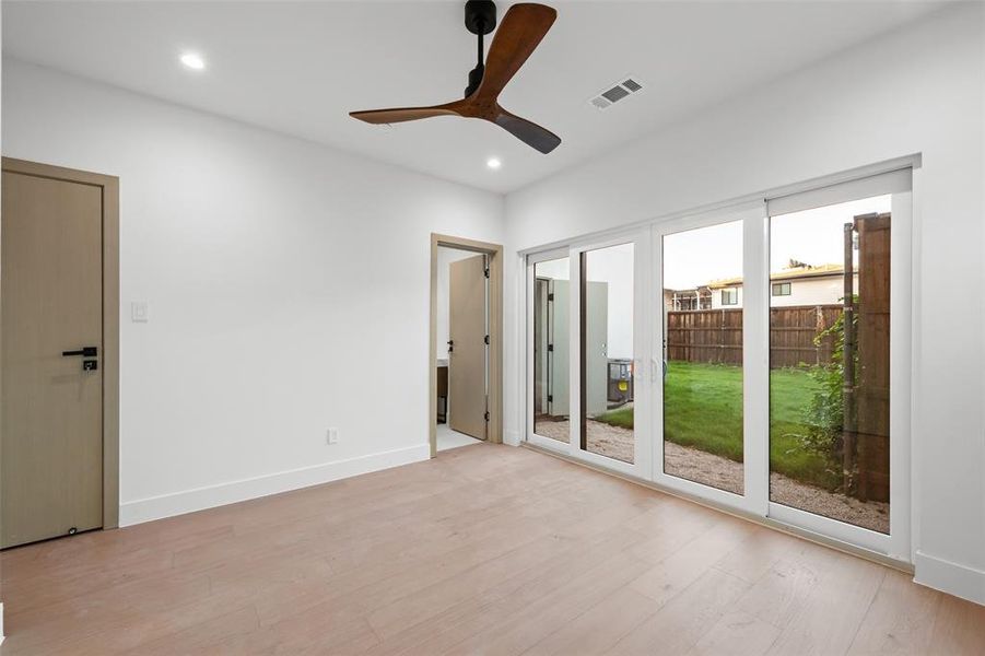 Unfurnished bedroom with light wood-type flooring, ceiling fan, recessed lighting, and access to exterior