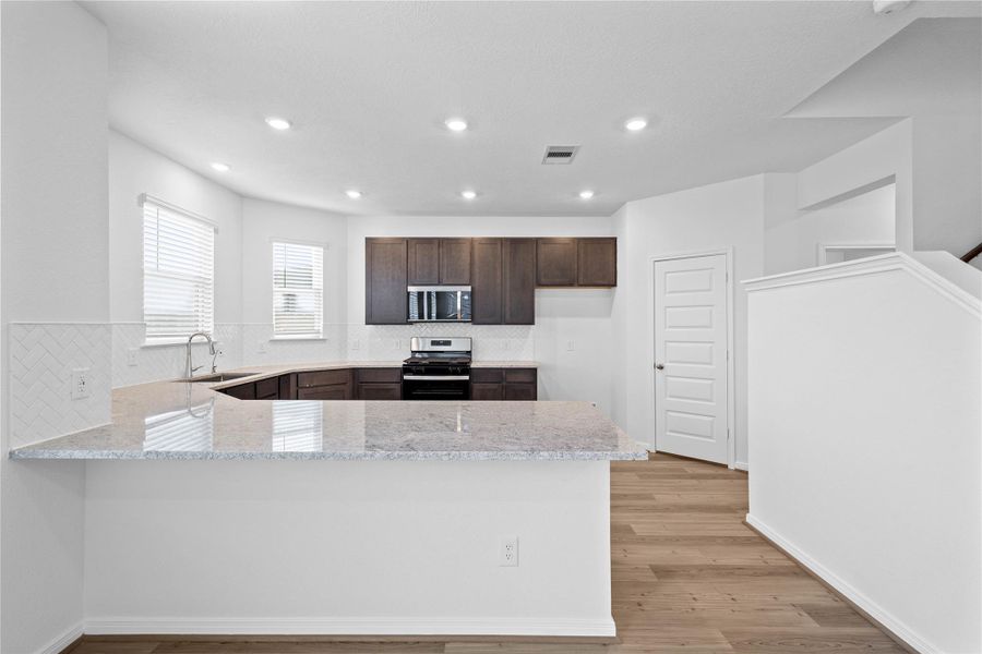 This spacious kitchen has it all—ample storage, generous counter space, and a layout that truly makes it the heart of the home. This spacious kitchen has it all—ample storage, generous counter space, and a layout that truly makes it the heart of the home.