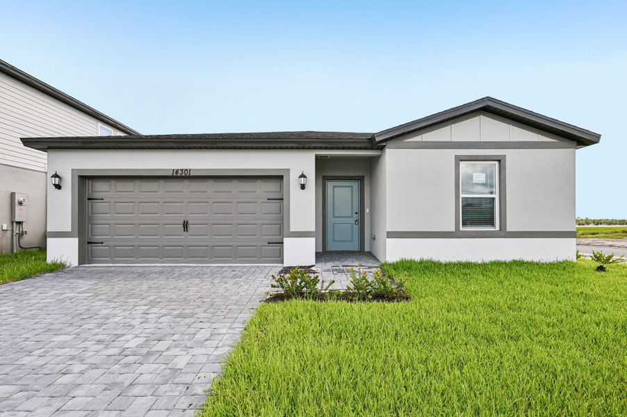 Front exterior of a new home in Meritage Homes at Terra Lago - Classic Series, Indiantown, FL, highlighting curb appeal (Image 1). Front exterior of a new home in Meritage Homes at Terra Lago - Classic Series, Indiantown, FL, highlighting curb appeal (Image 1).