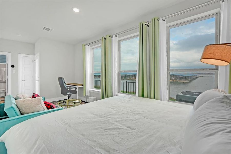 Bedroom featuring recessed lighting and a water view