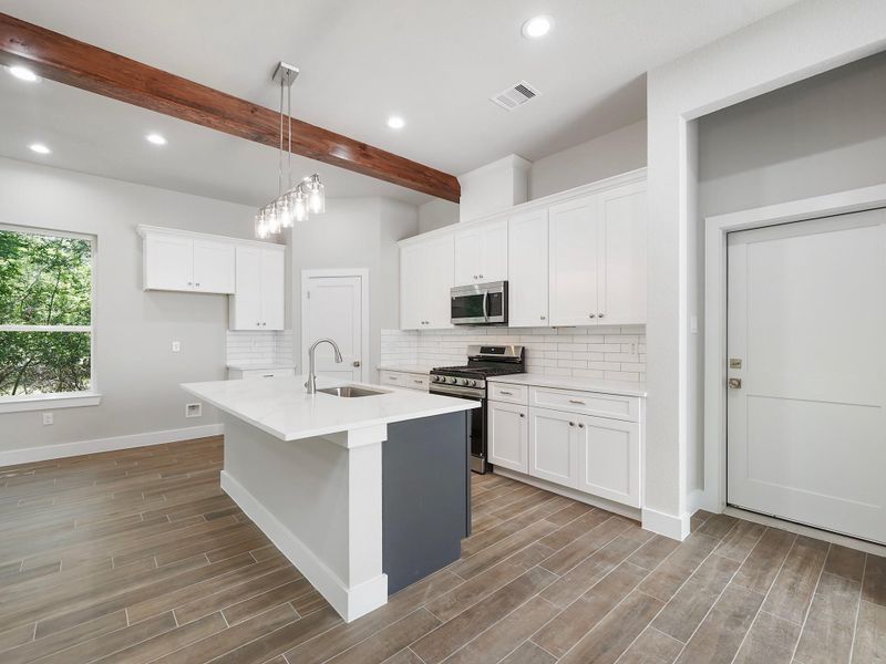 Kitchen is mix of navy blue island and white cabinets Kitchen is mix of navy blue island and white cabinets