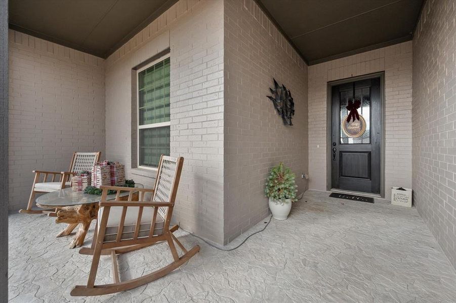 Long and lovely front porch with stamped concrete accent