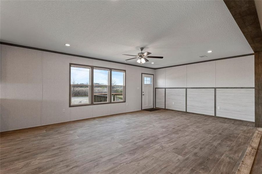 Unfurnished bedroom featuring light wood-type flooring, crown molding, a ceiling fan, recessed lighting, and a textured ceiling