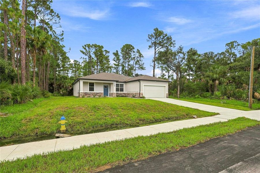 Front exterior of a new home in , North Port, FL, highlighting curb appeal (Image 17).