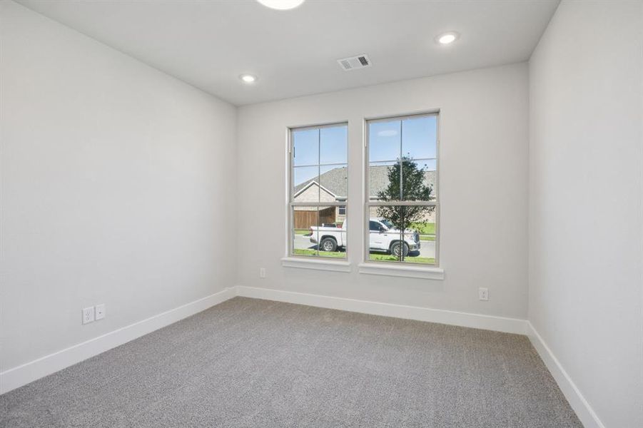 Spare room featuring light colored carpet and recessed lighting