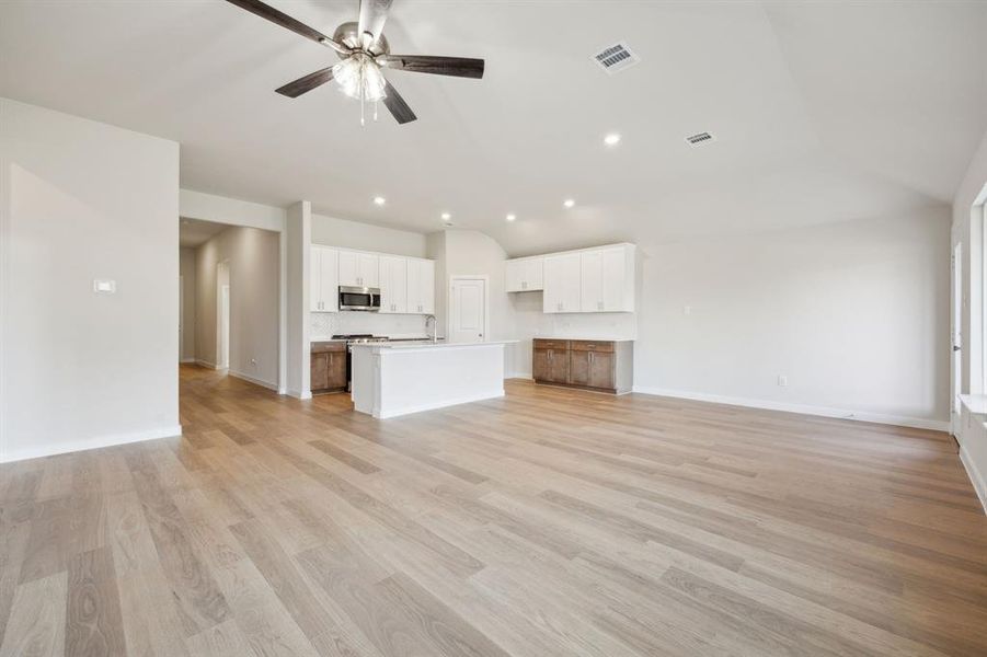 Another view of the living room and kitchen showing the dining area.