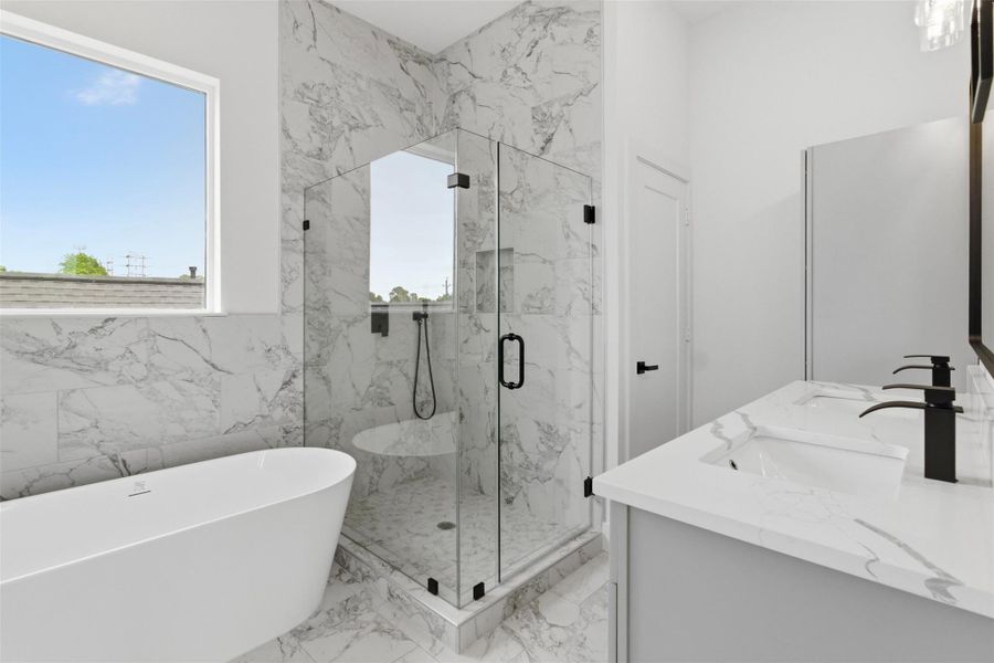 Spa inspired bathroom with freestanding soaking tub and glass enclosed shower