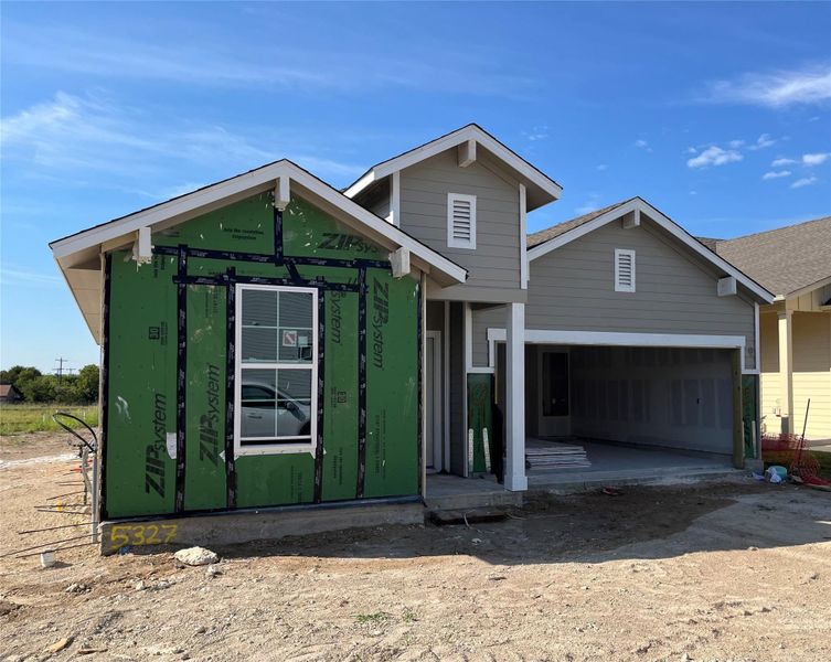 Front exterior of a new home in Wellspring, Round Rock, TX, highlighting curb appeal (Image 7). Front exterior of a new home in Wellspring, Round Rock, TX, highlighting curb appeal (Image 7).