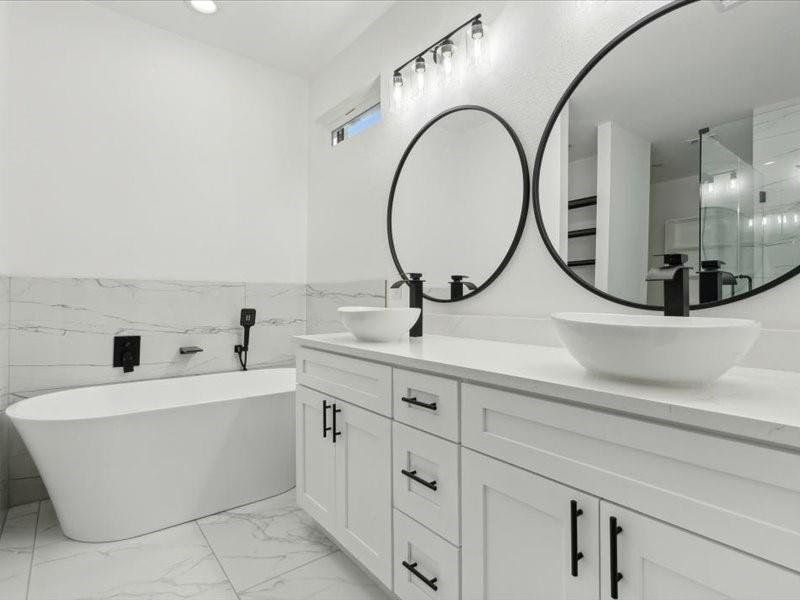 Bathroom featuring vanity, tile walls, tile patterned floors, and shower with separate bathtub