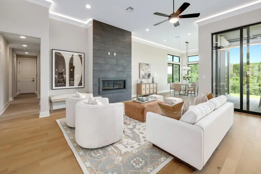 A spacious, luminous living area with a sleek fireplace and ample room to relax and entertain.