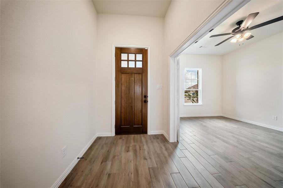 Entrance foyer featuring wood finished floors and a ceiling fan
