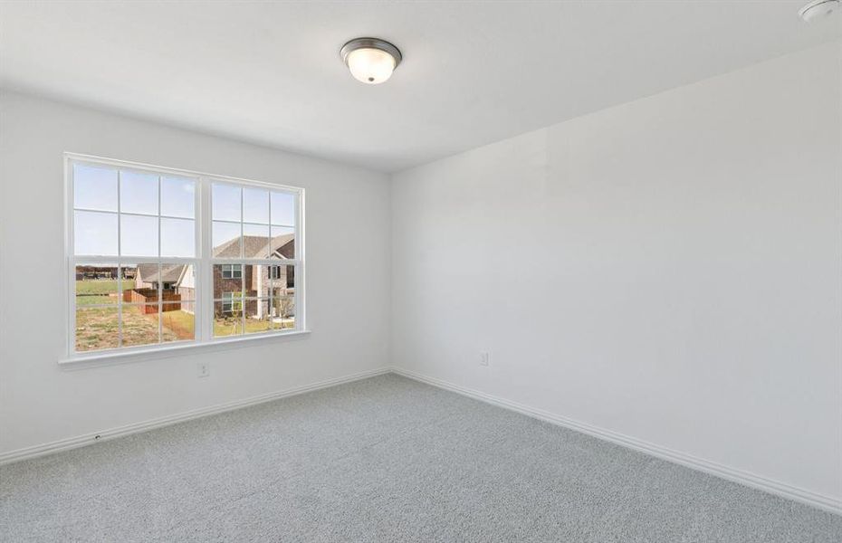 Spacious secondary bedroom with large windows