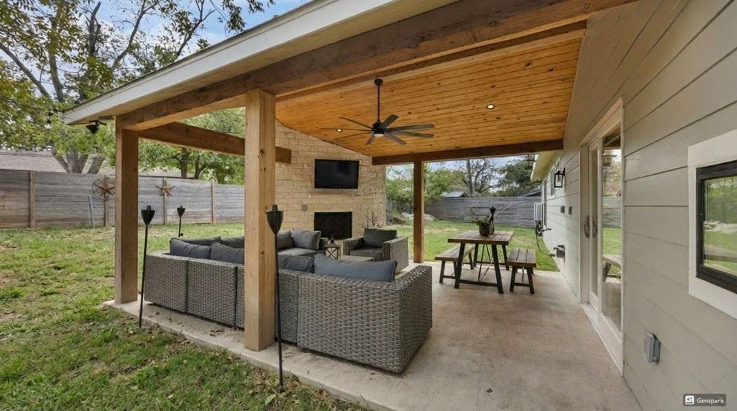 Fenced backyard with ceiling fan, a patio, and an outdoor living space with a fireplace