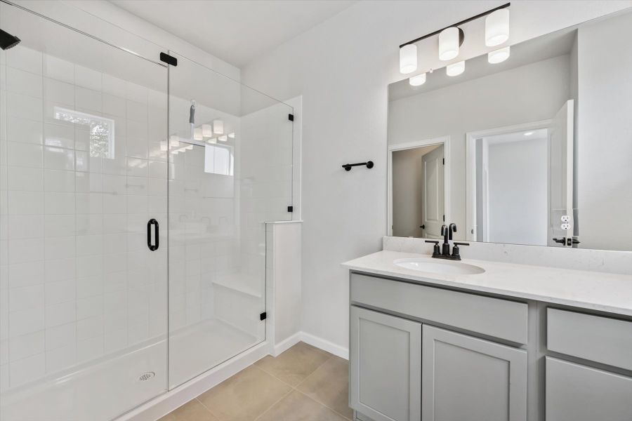 A bathroom with a sink and shower. A bathroom with a sink and shower.