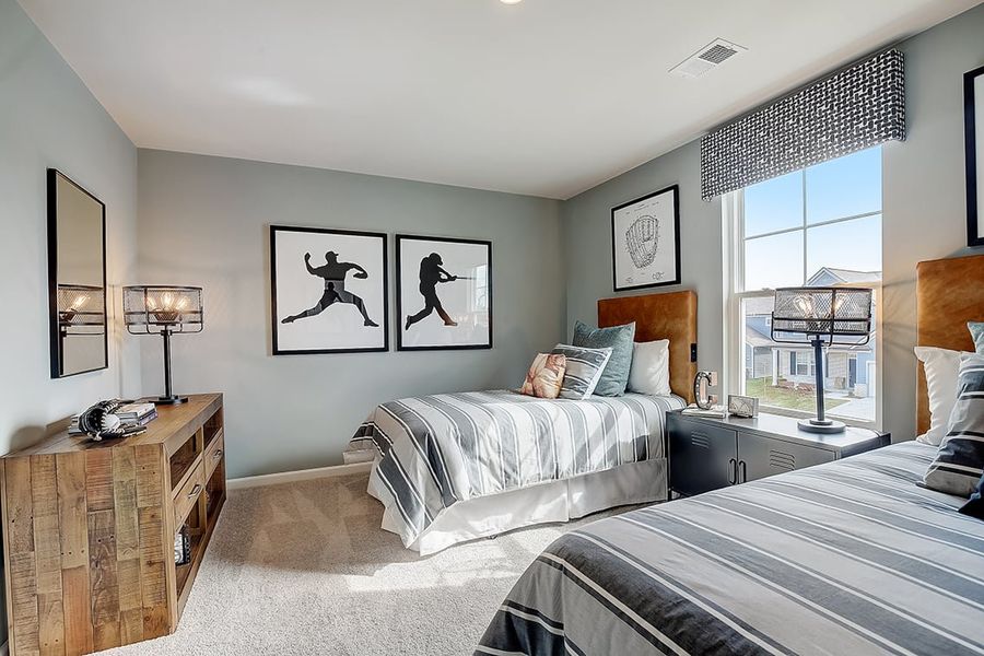 A bedroom with a bed and a window.