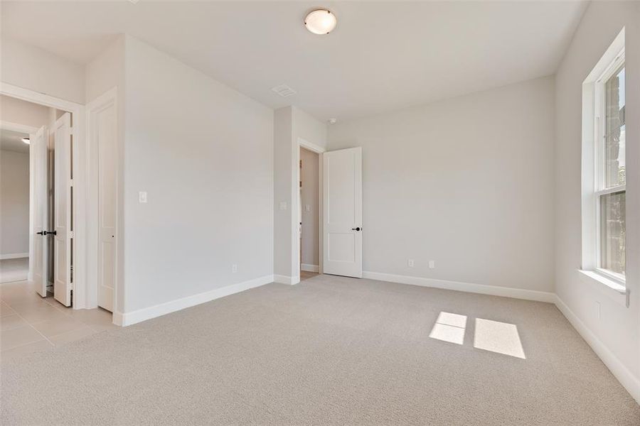Spare room with light colored carpet