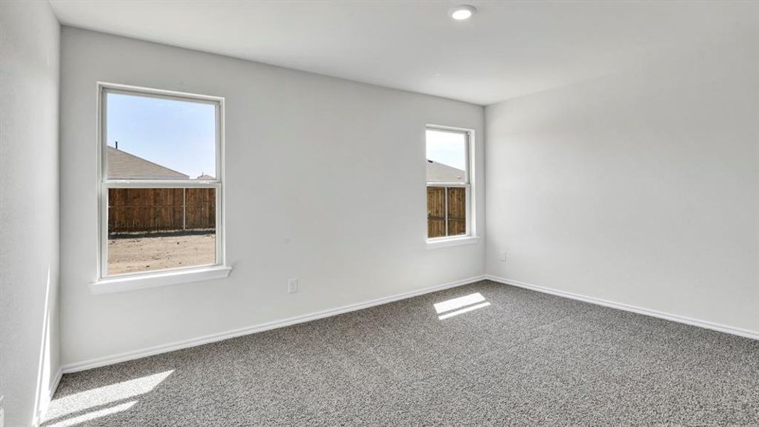 Spare room featuring carpet floors and baseboards