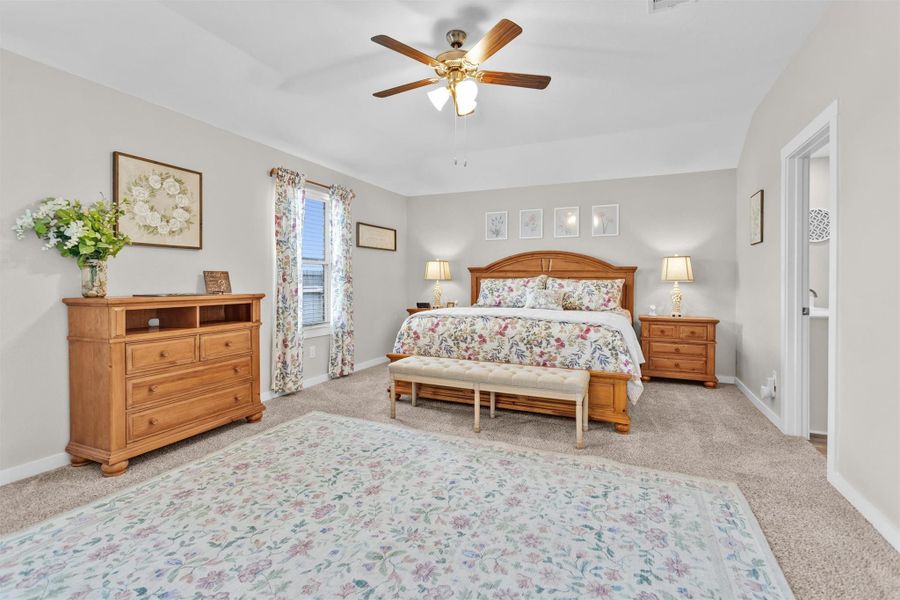 This spacious bedroom features ample natural light.