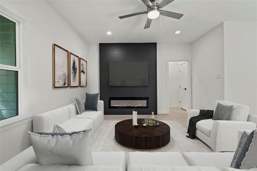 Living area with recessed lighting, a large fireplace, and a ceiling fan