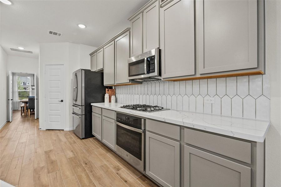 Maplewood cabinets and calacatta Quartz