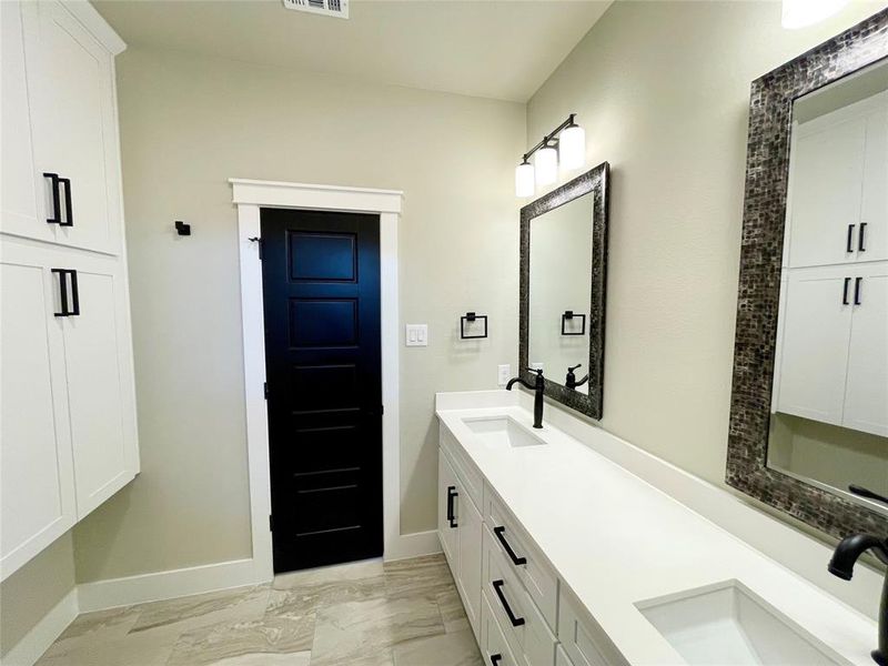 Bathroom with tile patterned flooring and vanity