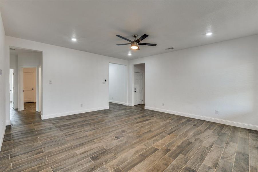 Empty room featuring wood tiled floors, recessed lighting, and ceiling fan Empty room featuring wood tiled floors, recessed lighting, and ceiling fan