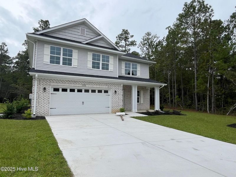 Front exterior of a new home in Palmetto Creek, Bolivia, NC, highlighting curb appeal (Image 2).