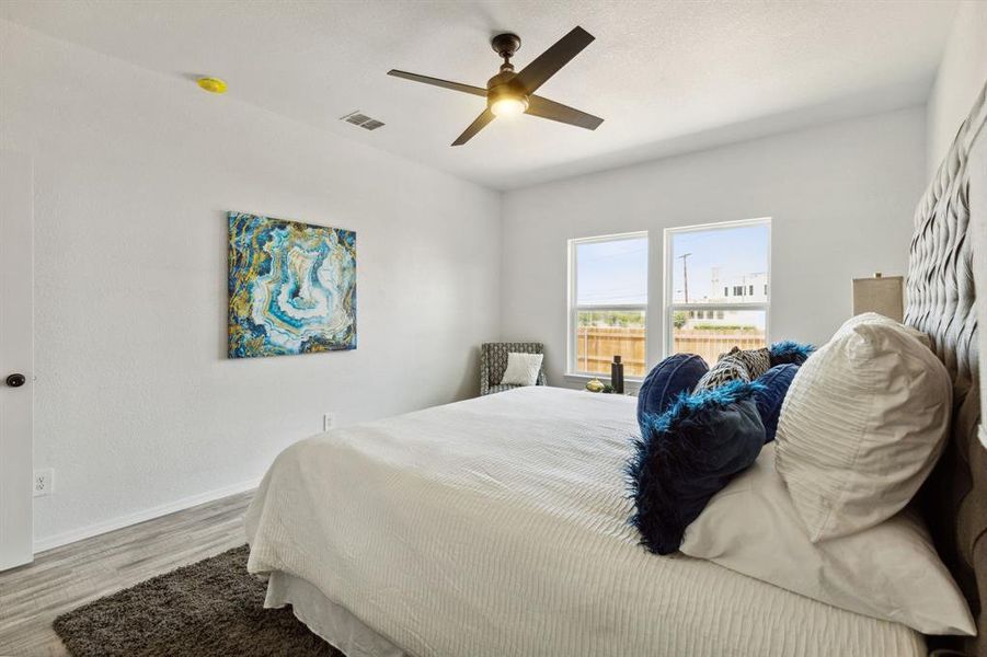 Bedroom with ceiling fan and hardwood / wood-style flooring