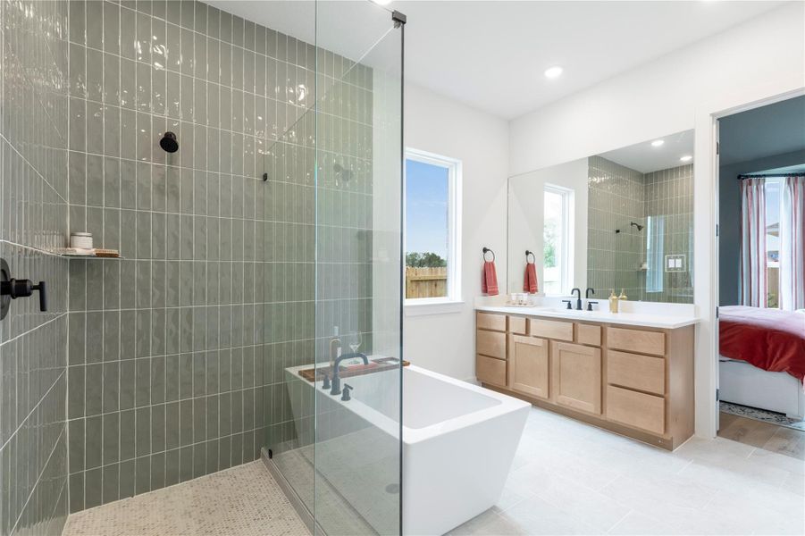 Ensuite bathroom with a soaking tub, a walk in shower, vanity, and recessed lighting Ensuite bathroom with a soaking tub, a walk in shower, vanity, and recessed lighting