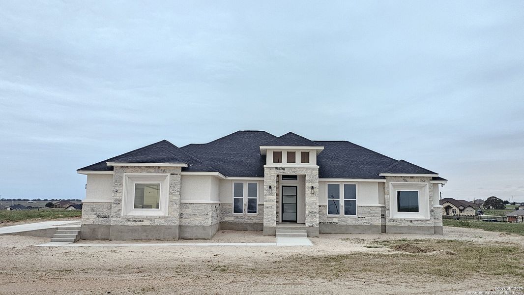 Front exterior of a new home in , La Vernia, TX, highlighting curb appeal (Image 2).