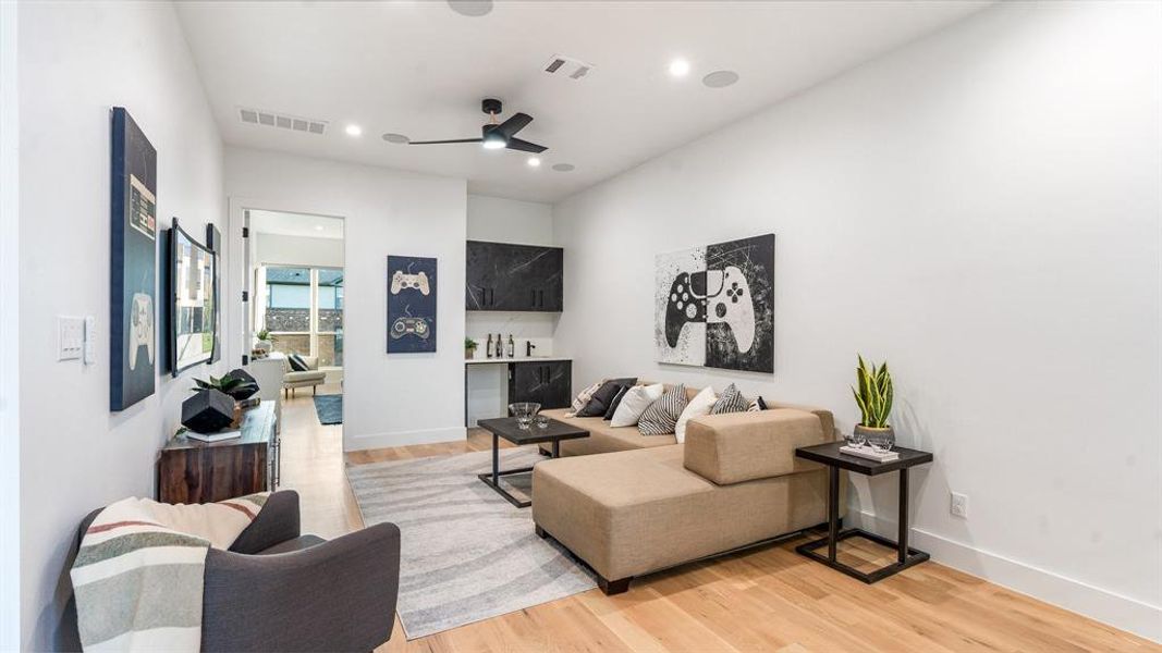 Living room featuring ceiling fan and light hardwood / wood-style floors