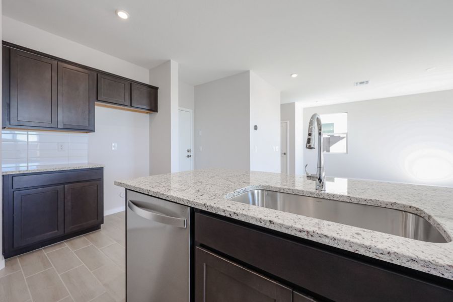 A large kitchen with marble counters.