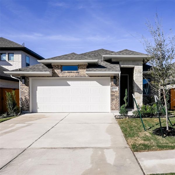 Front exterior of a new home in Crosswinds, Kyle, TX, highlighting curb appeal (Image 2).
