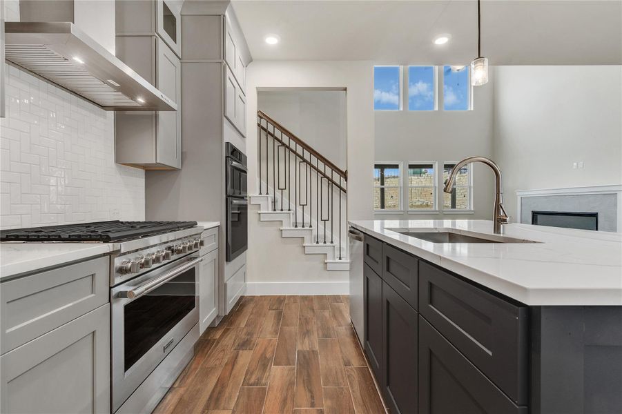 A contemporary kitchen with an island, sleek appliances, and open-concept design that flows into the living space.