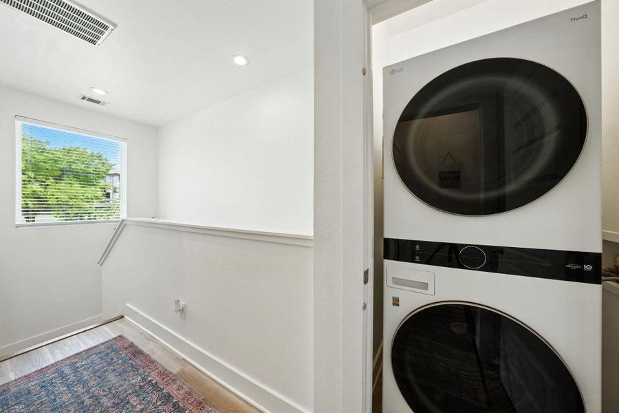 Laundry room featuring stacked washer and dryer Laundry room featuring stacked washer and dryer