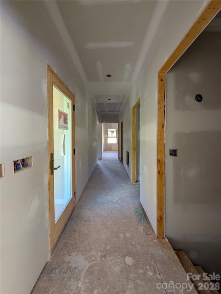 Entry Hallway from Garage with stairs to basement access on right and access to covered decks to left